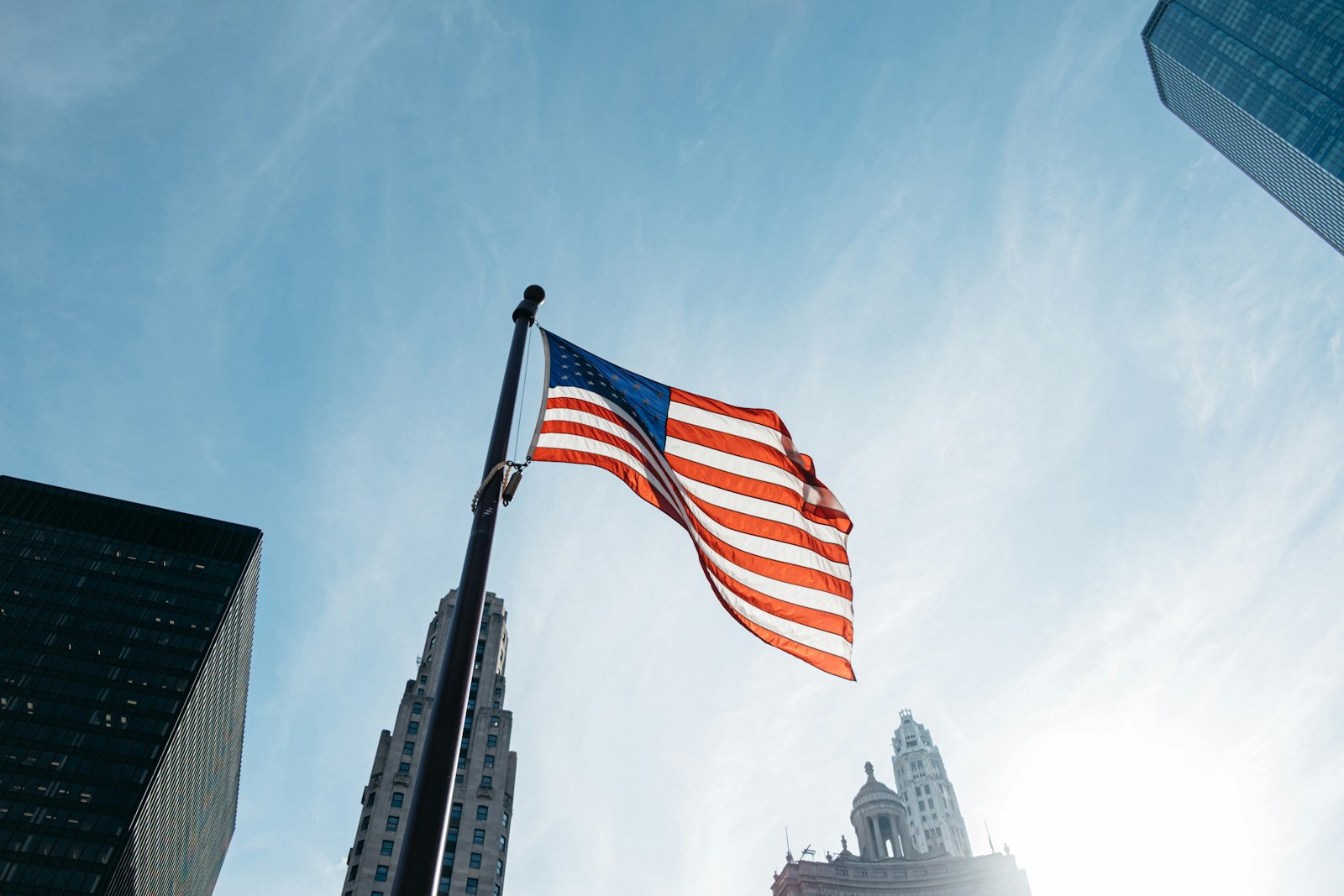 USA flag on pole at the city during day